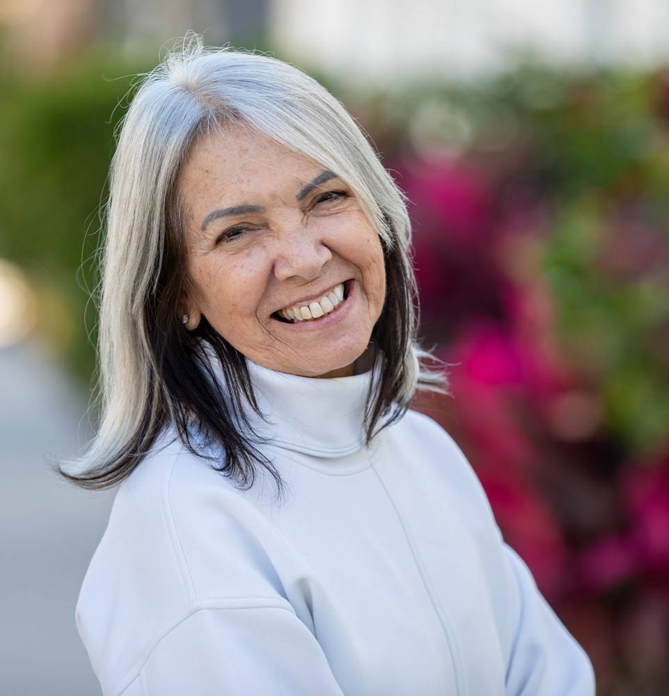 Dr. Cavalcanti's patient smiling outside of office